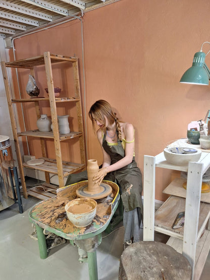 Model a ceramic vase and decorate it with flowers